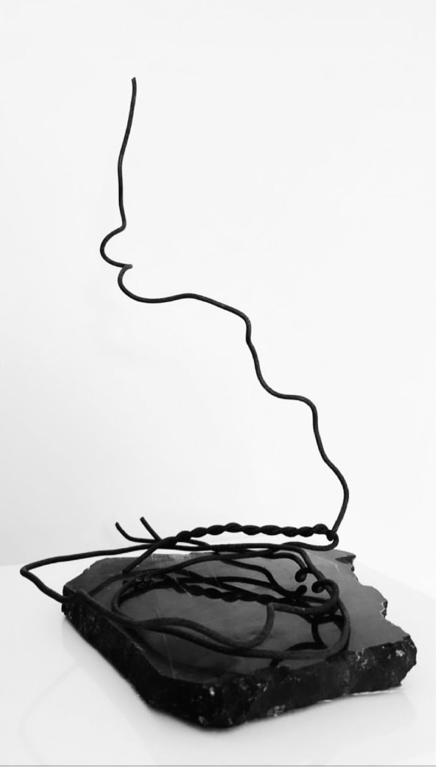 A Metal sculpture "Untitled" (Bez nosaukuma) on a stone base by Ieva Bondare