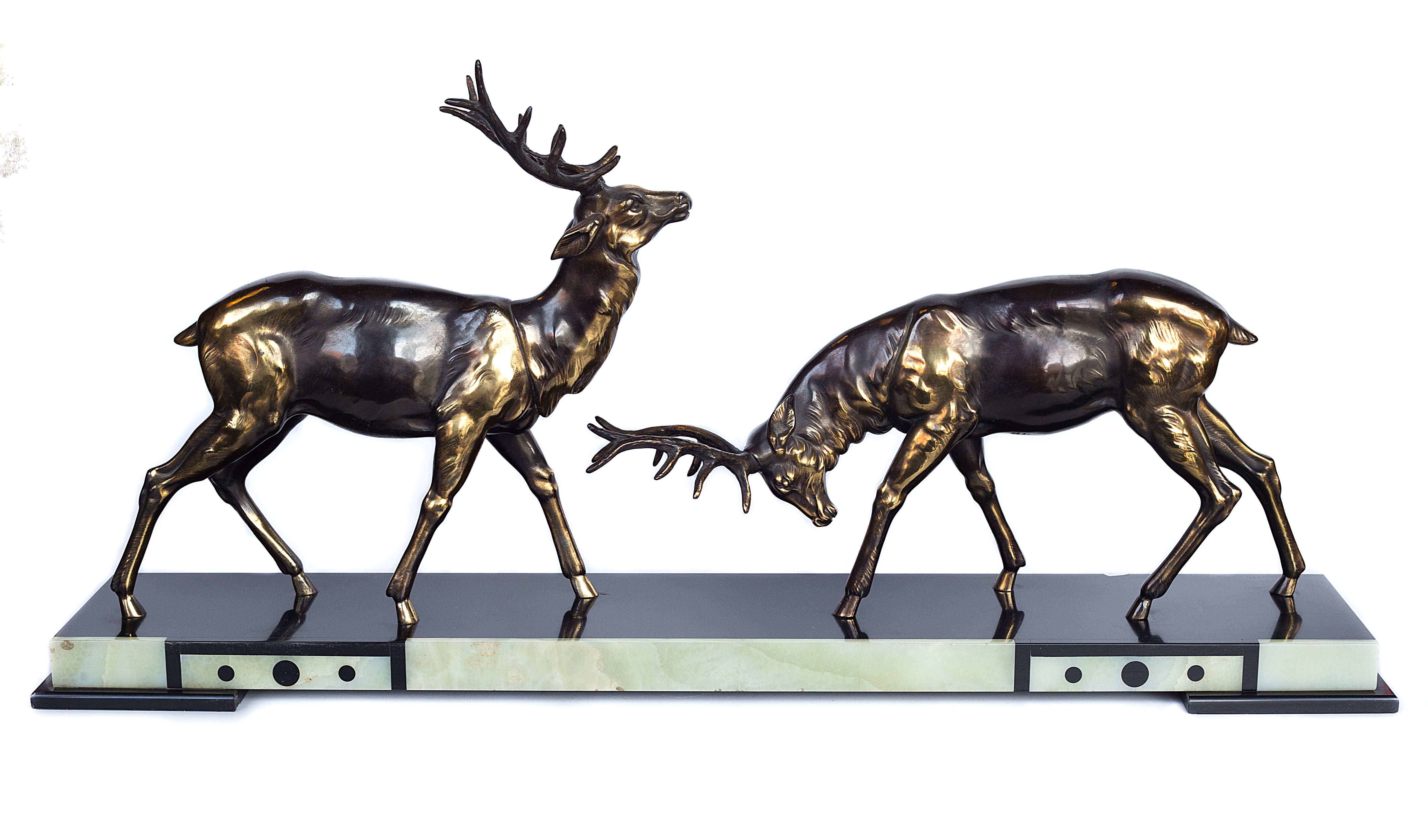 A 1930s Art Deco sculpture by Limousin captures the elegance of two deers poised gracefully atop a striking multi-colored marble base
