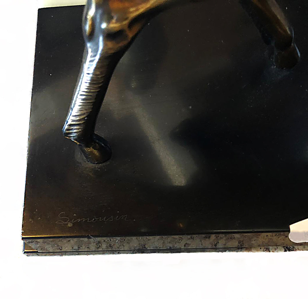 A 1930s Art Deco sculpture by Limousin captures the elegance of two deers poised gracefully atop a striking multi-colored marble base