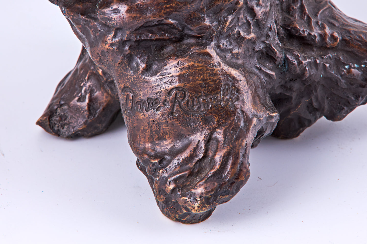 A 19th-century Art Deco sculpture by Dave Russell showcases an owl rendered in patinated bronze