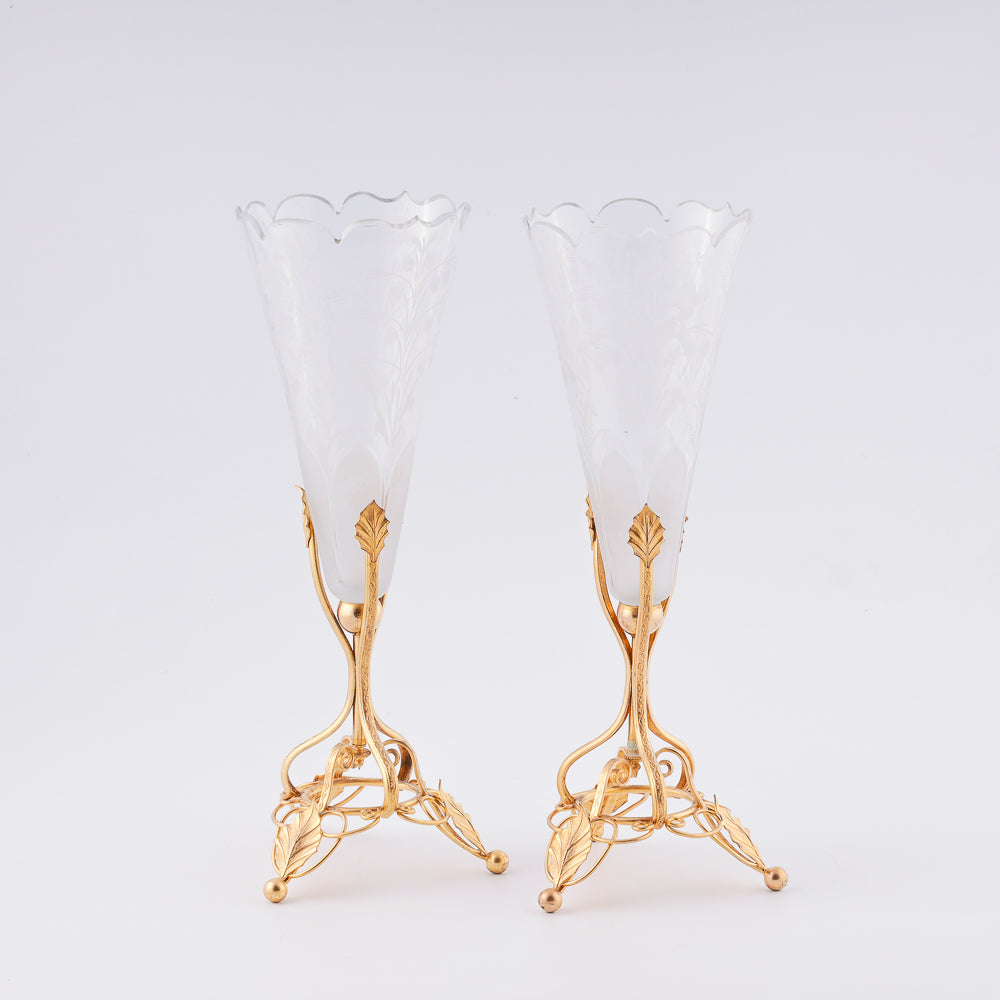 A pair of antique French crystal vases features large floral decorations