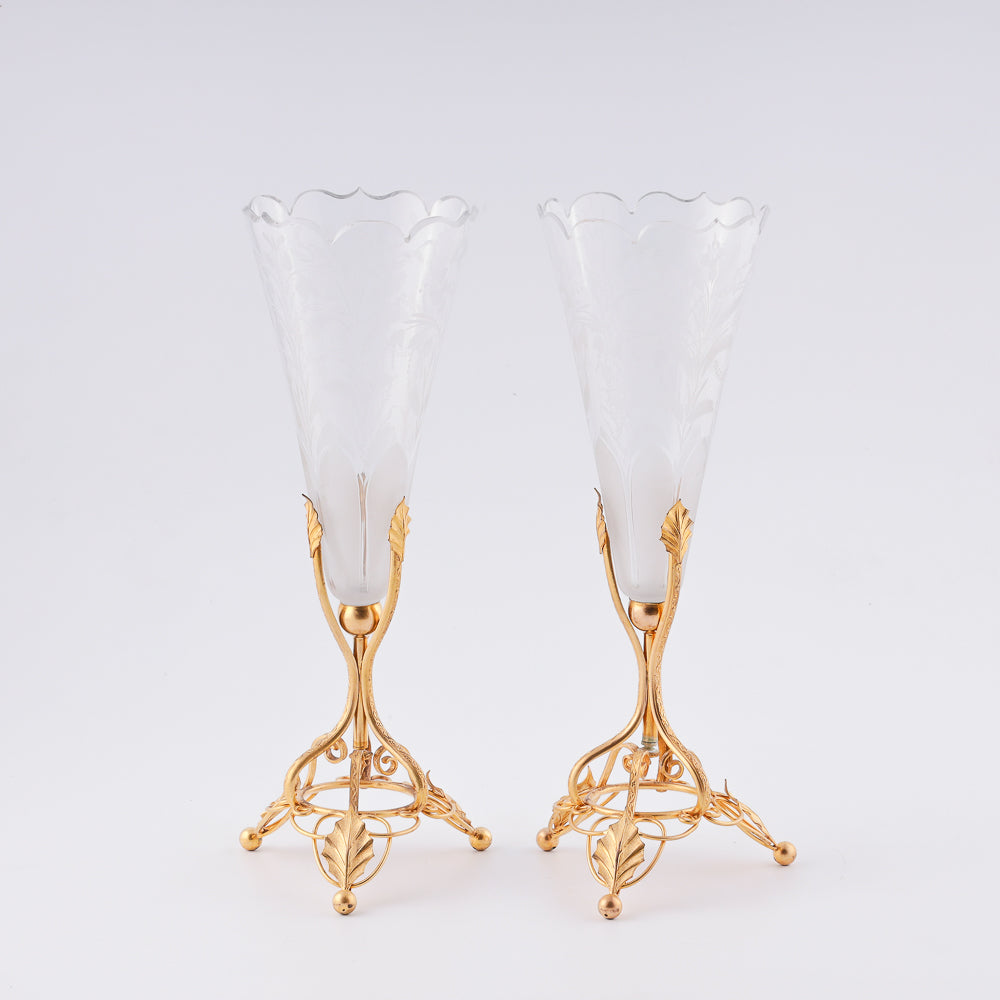 A pair of antique French crystal vases features large floral decorations
