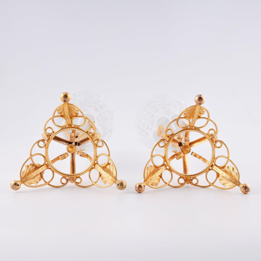 A pair of antique French crystal vases features large floral decorations