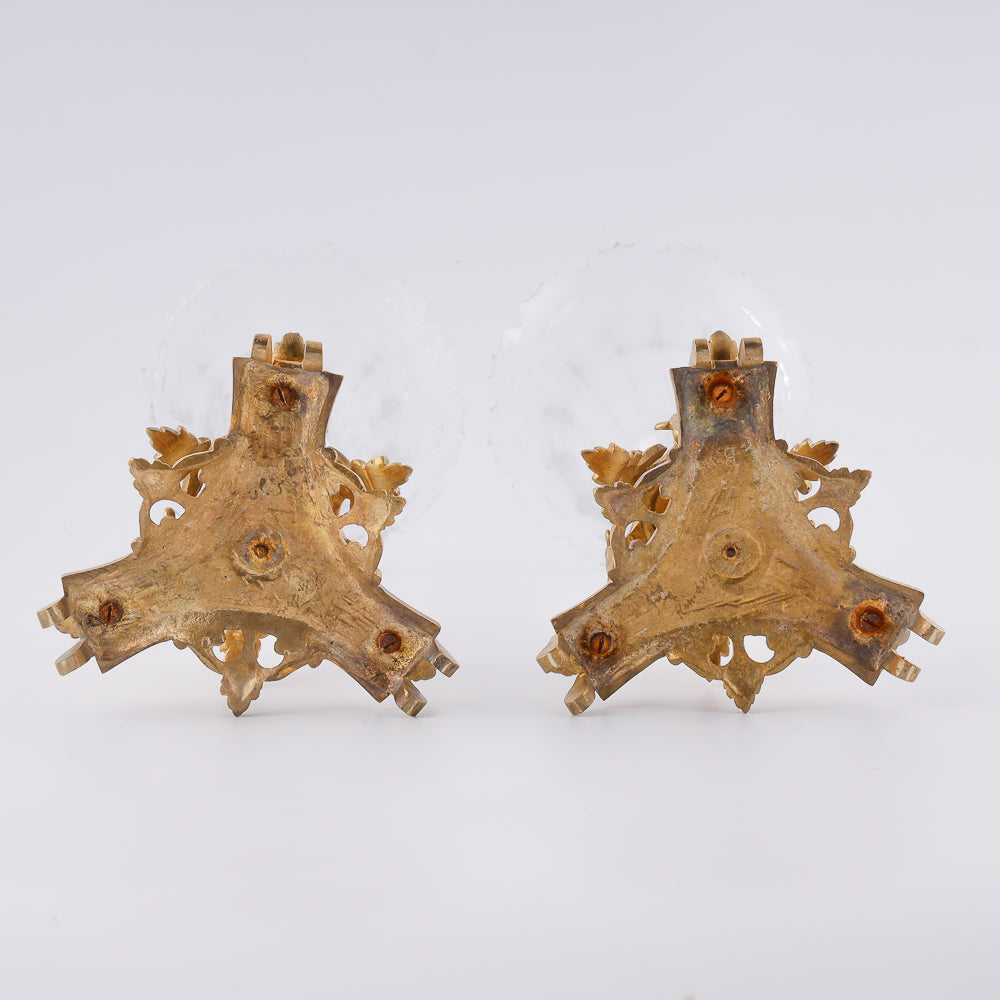 A pair of large antique crystal vases is elegantly set in gilded brass mountings