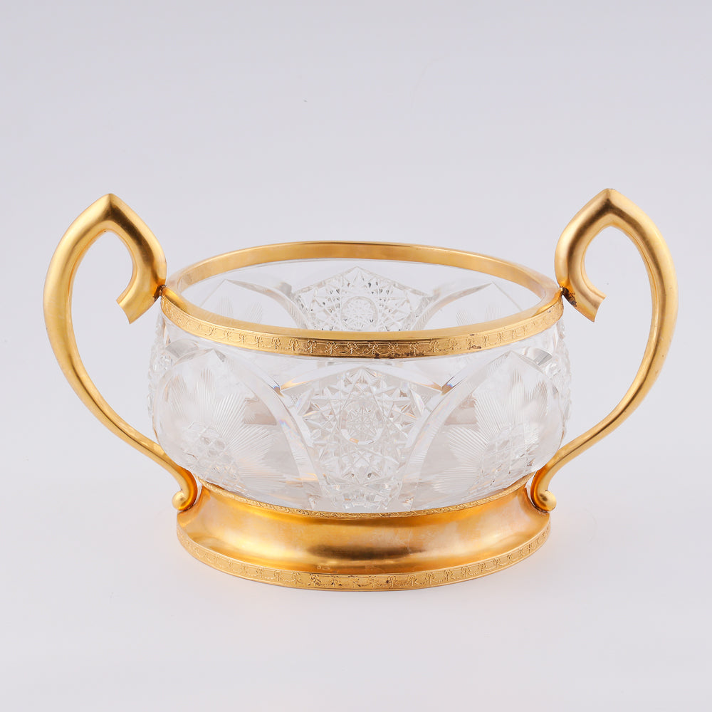 A substantial antique crystal vase features a striking Neogothical design