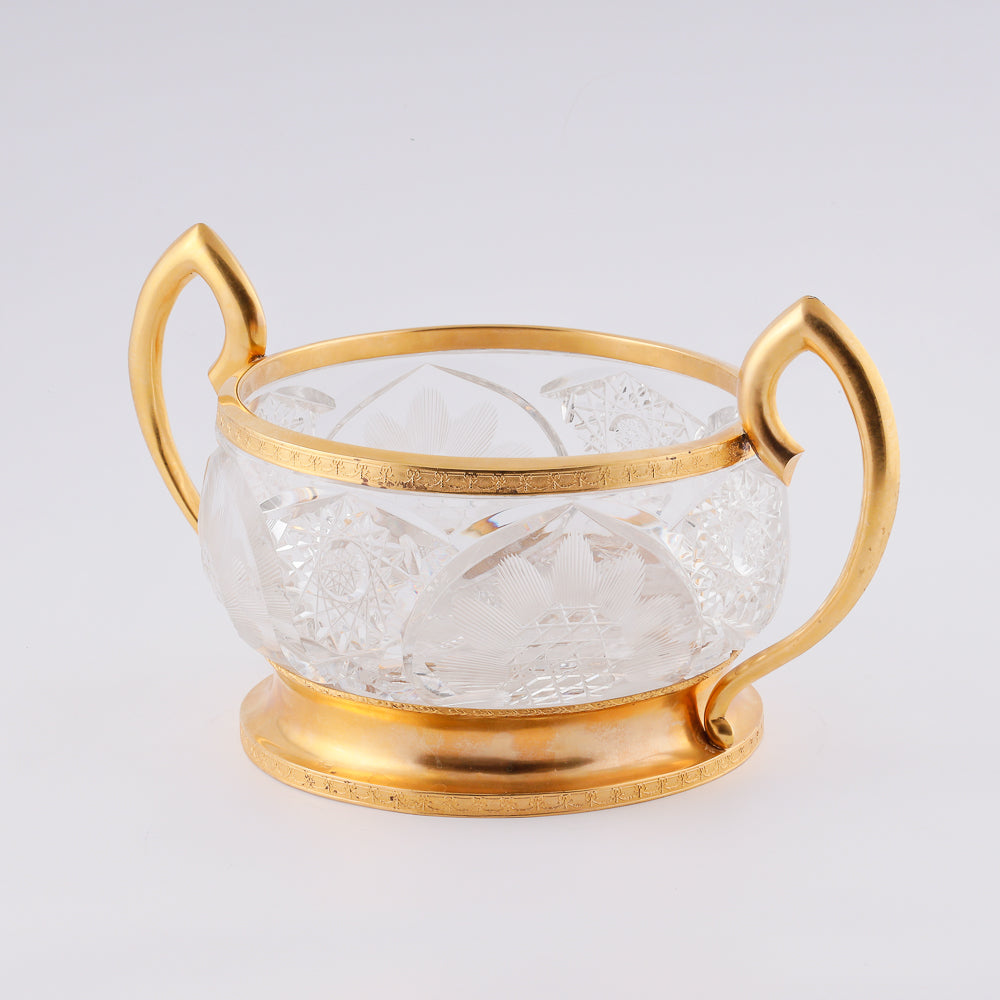 A substantial antique crystal vase features a striking Neogothical design