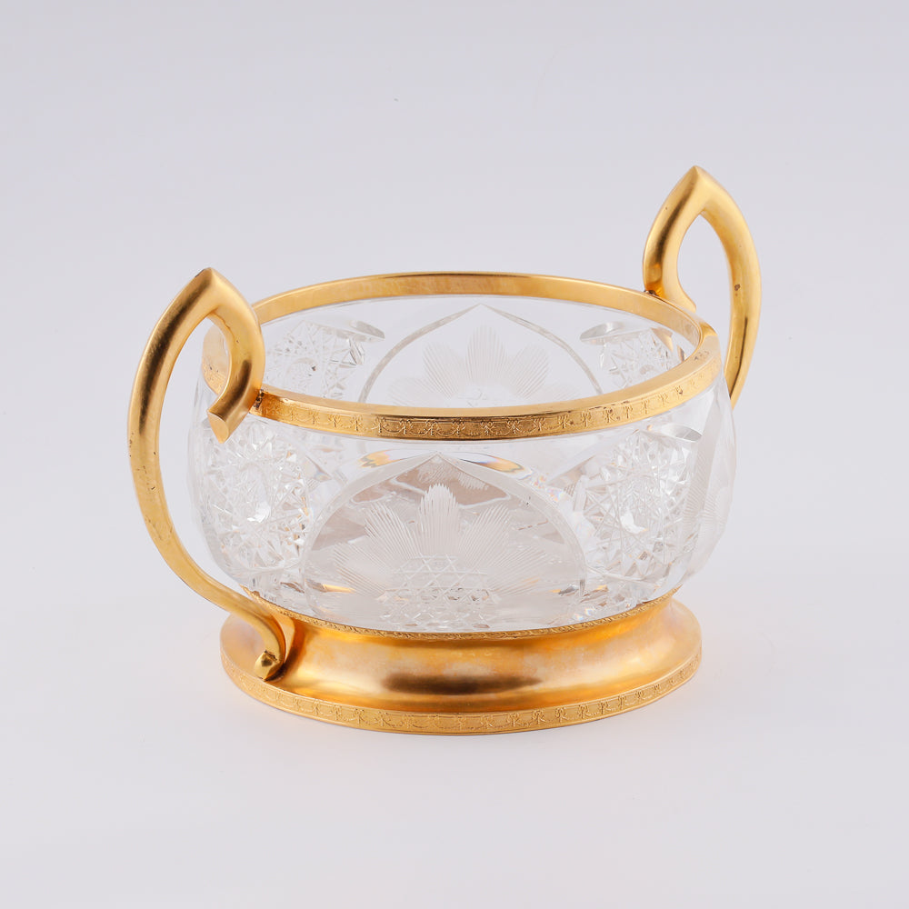 A substantial antique crystal vase features a striking Neogothical design