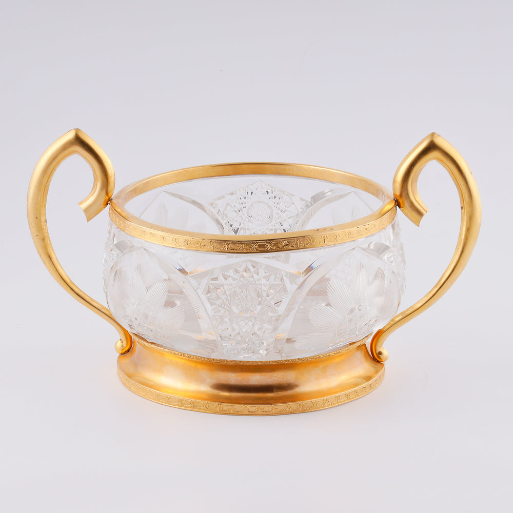 A substantial antique crystal vase features a striking Neogothical design