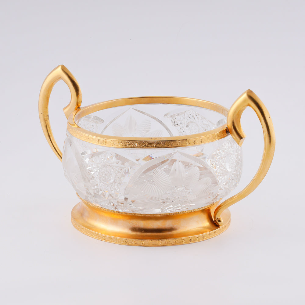 A substantial antique crystal vase features a striking Neogothical design