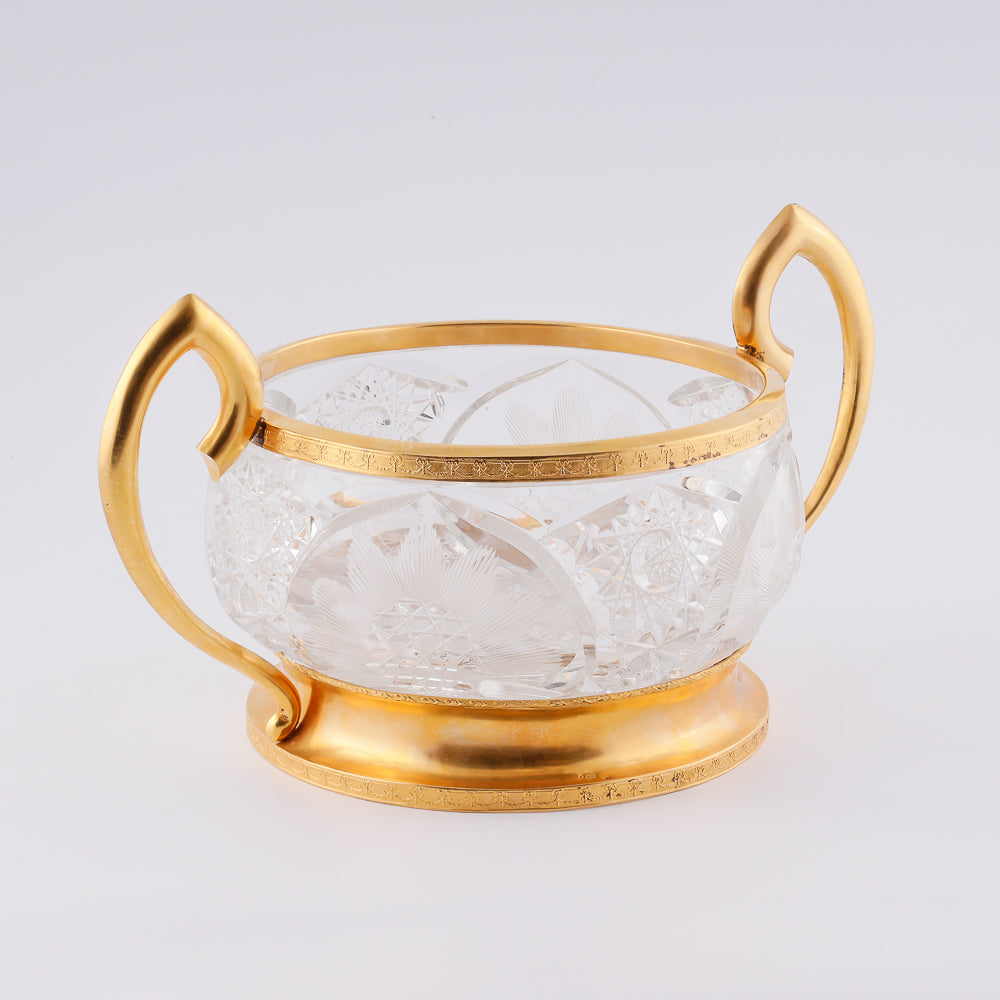 A substantial antique crystal vase features a striking Neogothical design