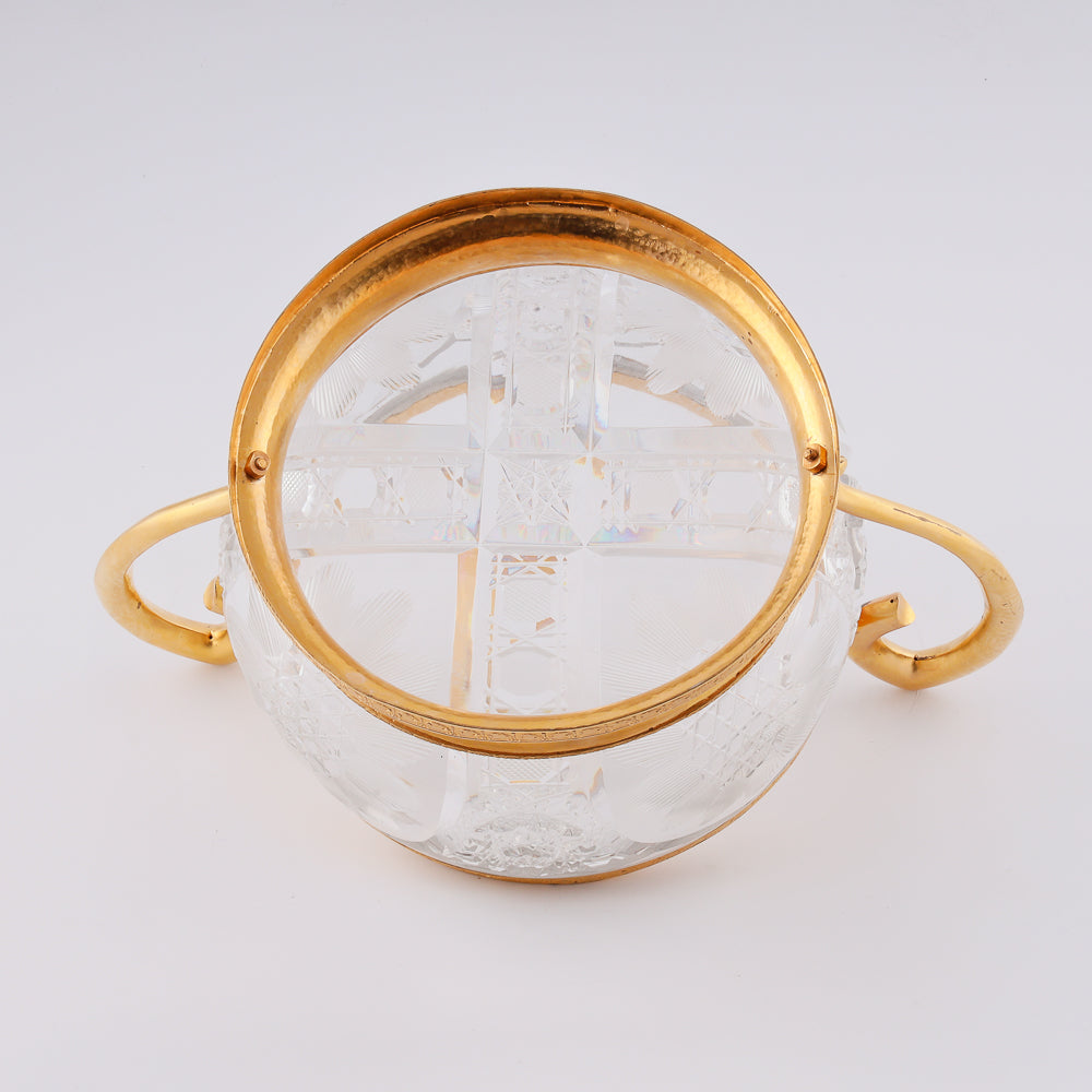 A substantial antique crystal vase features a striking Neogothical design