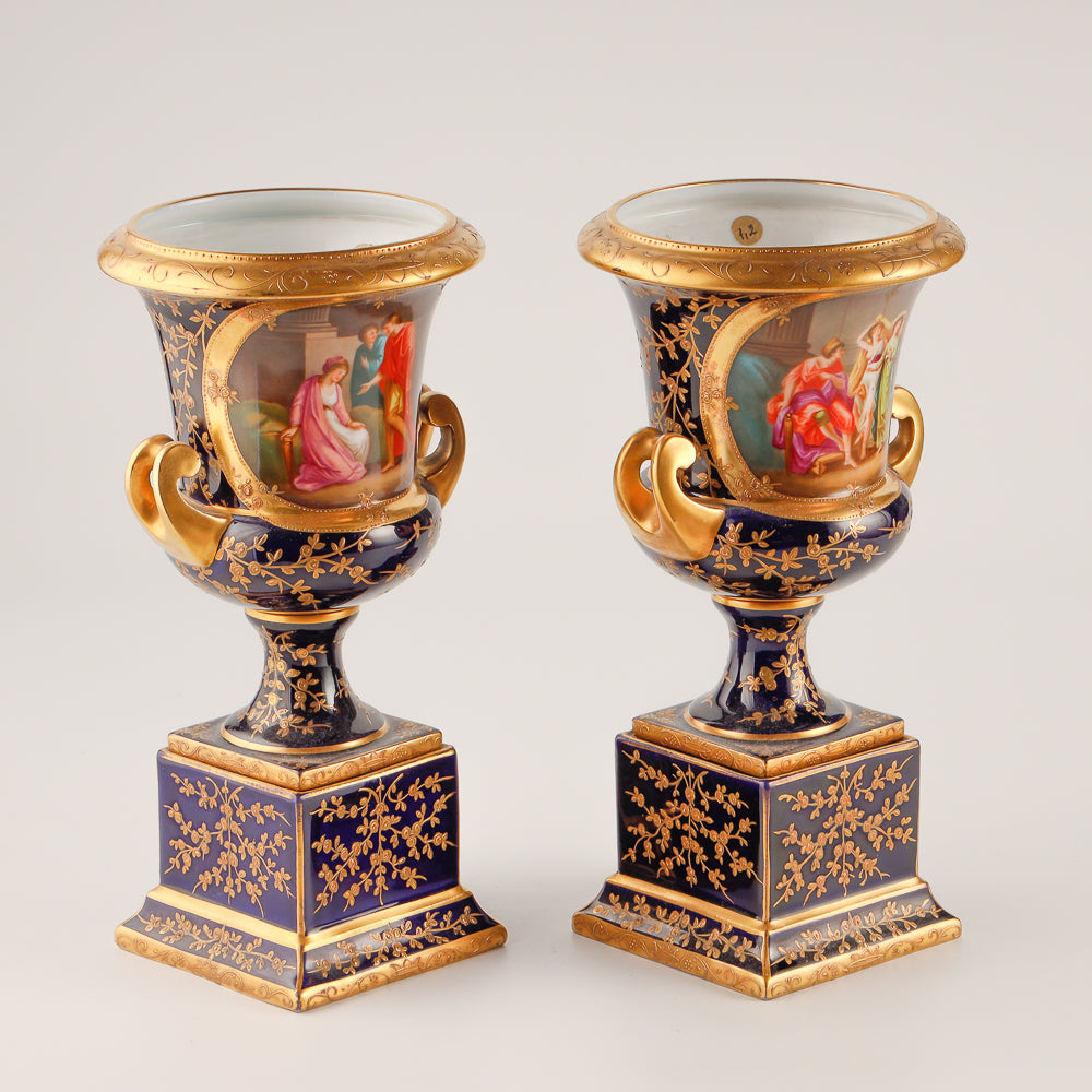 Pair of 19th century Royal Vienna vases features a rich cobalt blue glaze crafted as decorative salon porcelain
