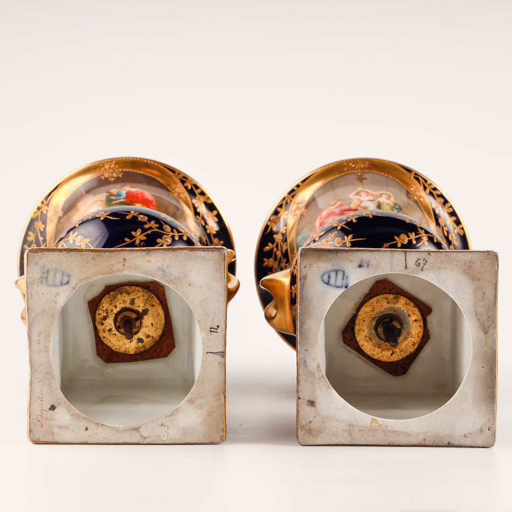 Pair of 19th century Royal Vienna vases features a rich cobalt blue glaze crafted as decorative salon porcelain