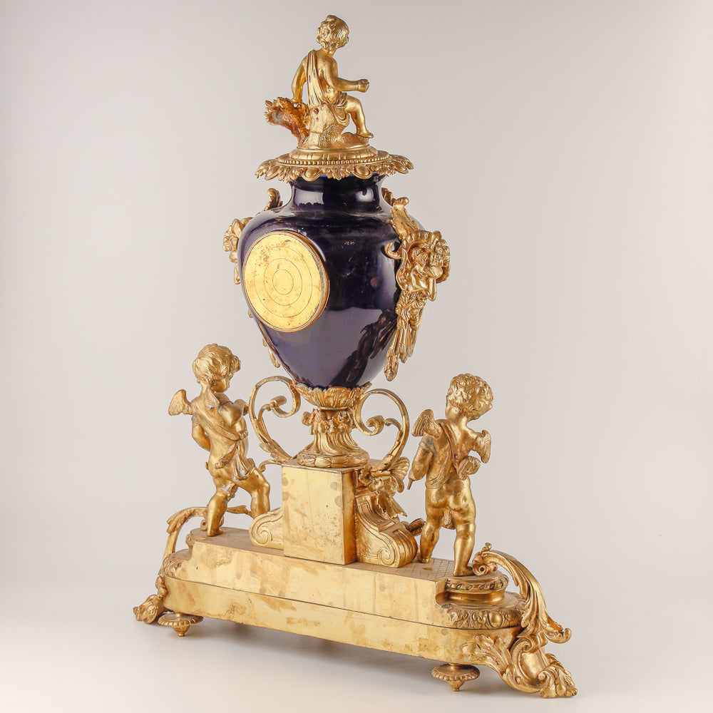 Gran reloj de salón azul cobalto con dos jarrones.