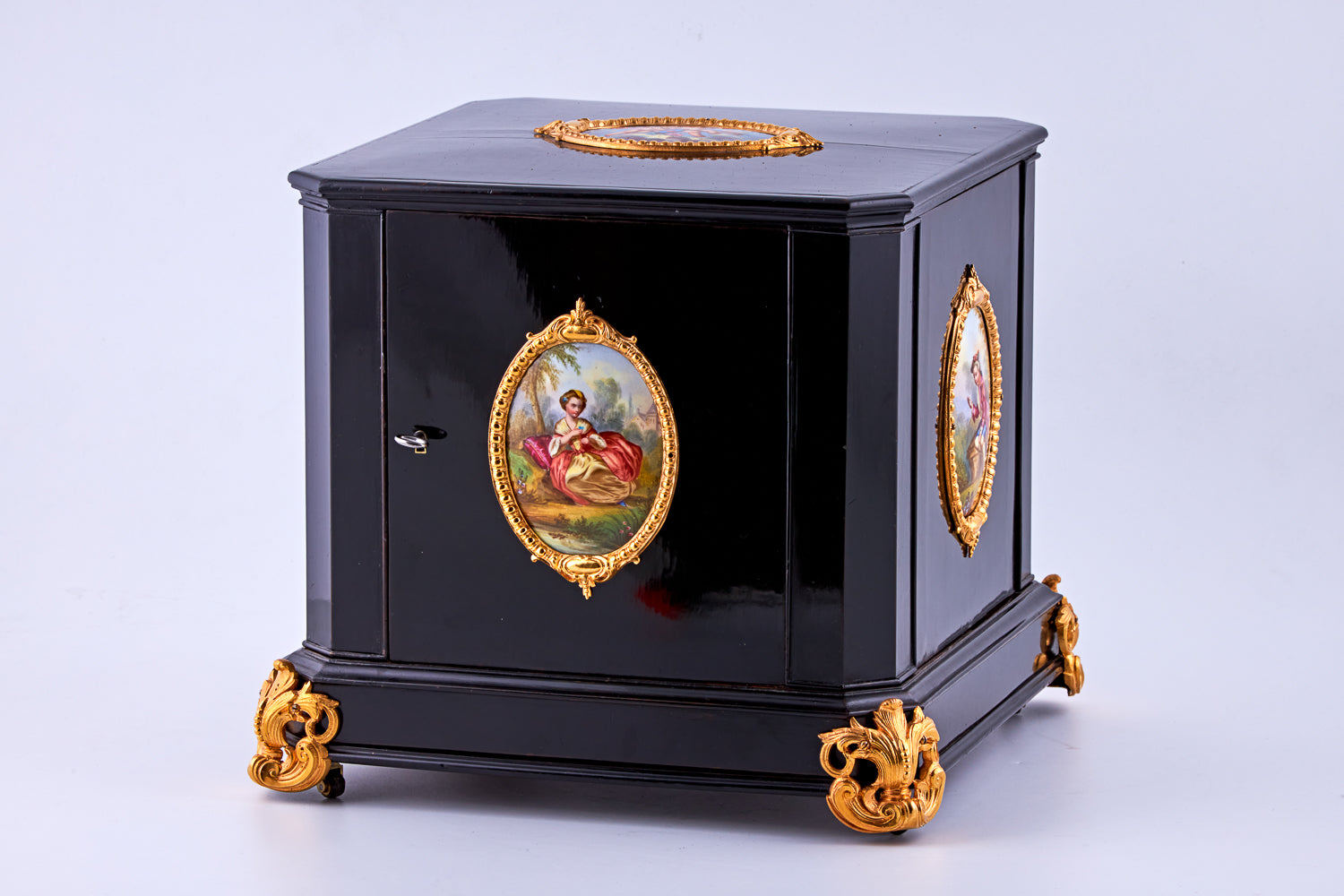 Antique 19th-century Napoleon III ebony cabinet featuring finely detailed Sèvres porcelain plaques