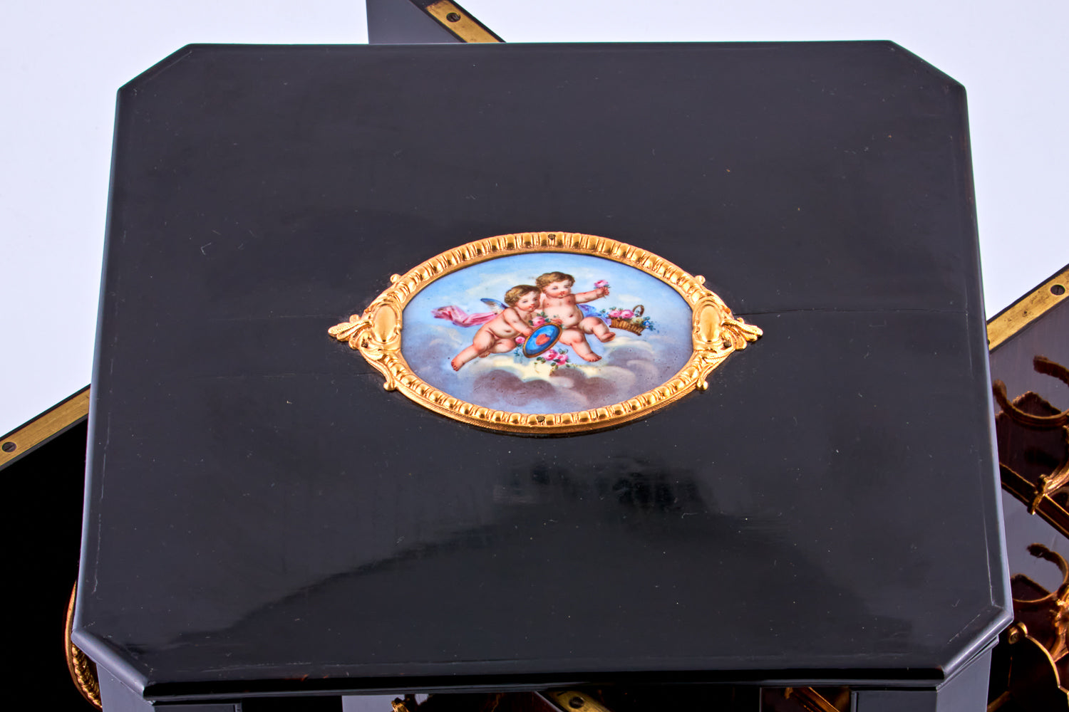 Antique 19th-century Napoleon III ebony cabinet featuring finely detailed Sèvres porcelain plaques