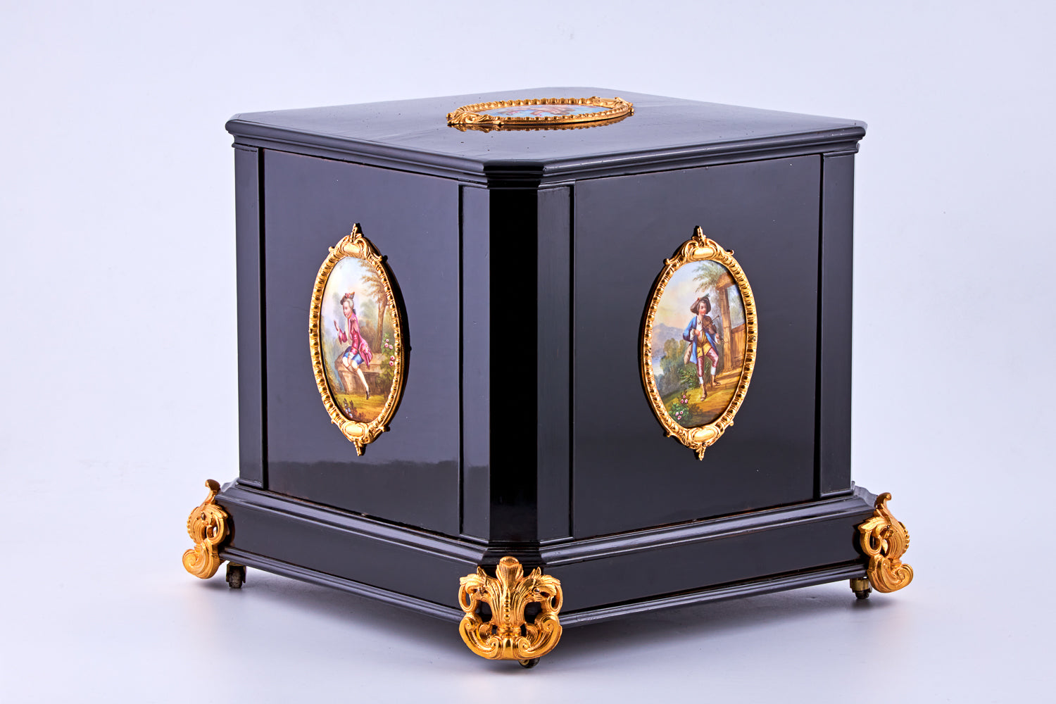 Antique 19th-century Napoleon III ebony cabinet featuring finely detailed Sèvres porcelain plaques