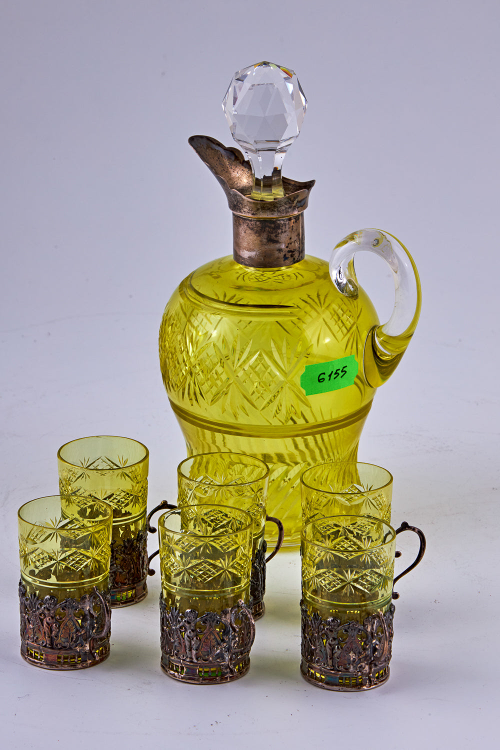 Antique set features a coloured crystal carafe accompanied by six crystal cups