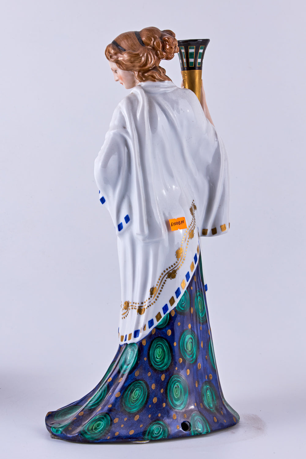 Hand-painted porcelain figurine of a woman with a torch