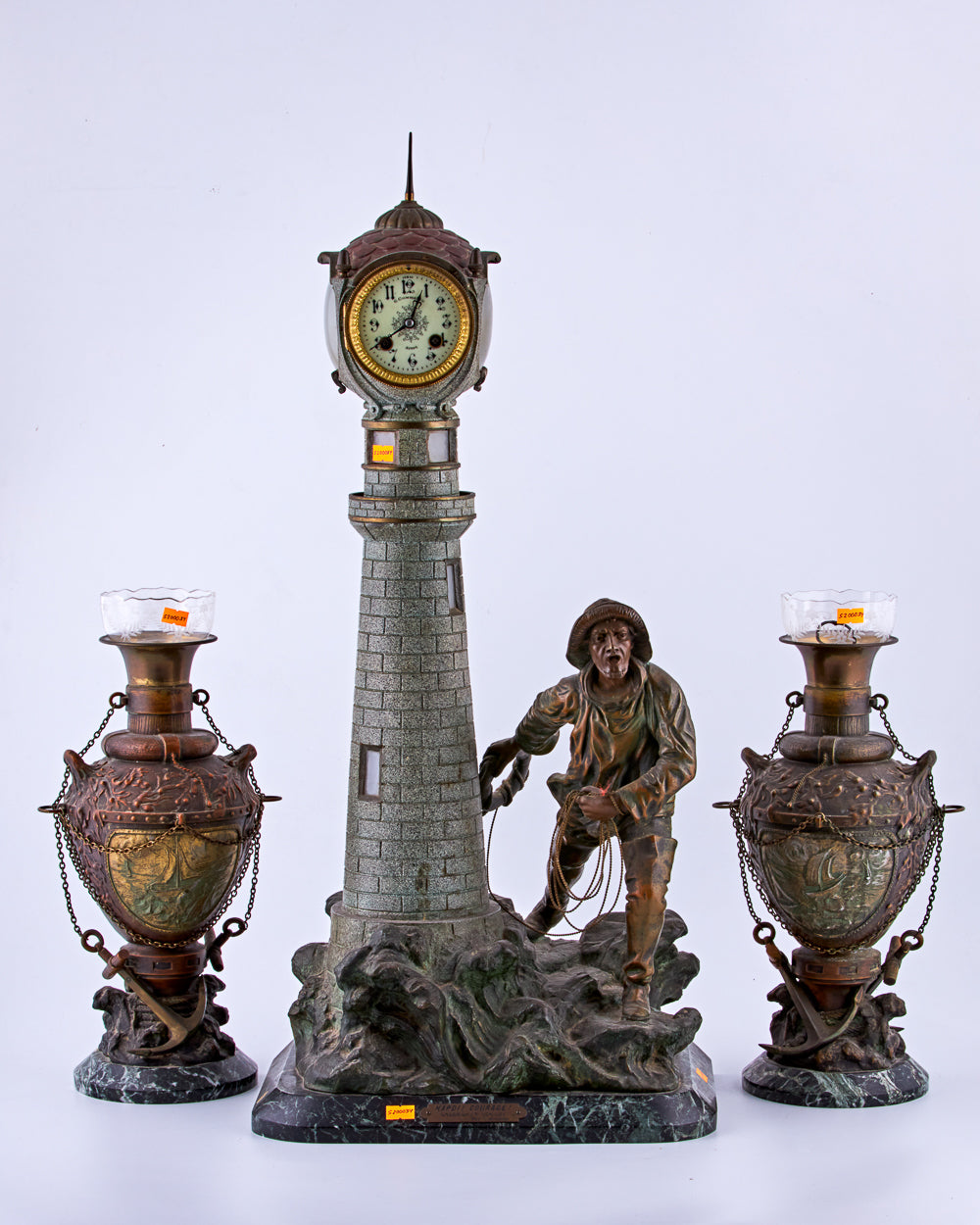 Antique distinguished spelter set captures a captivating maritime scene featuring a lighthouse and a fisherman