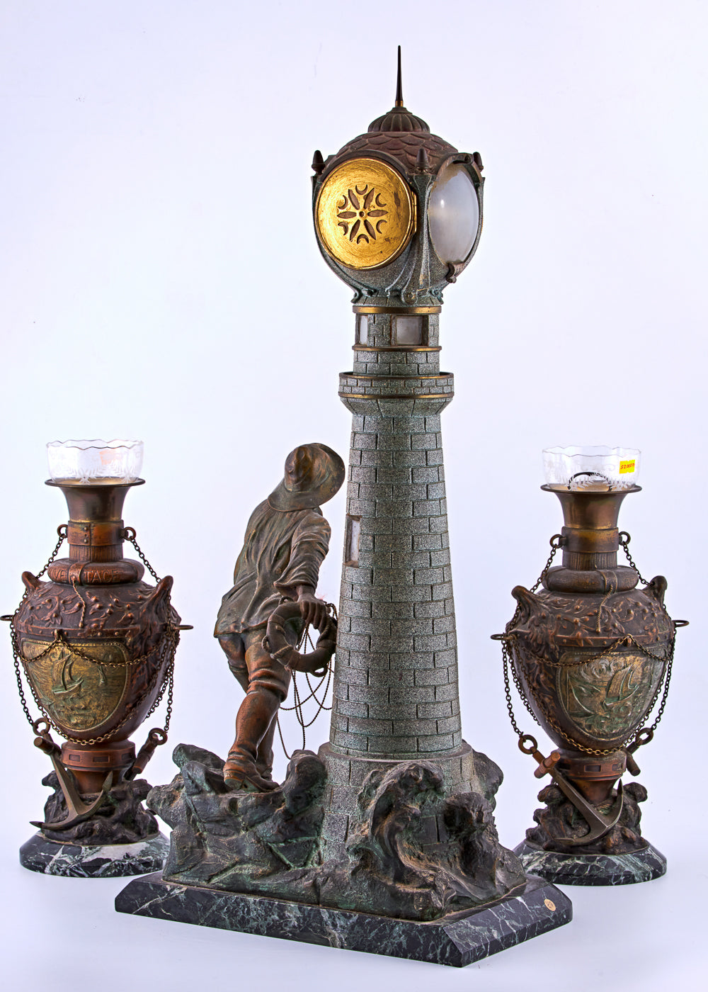 Antique distinguished spelter set captures a captivating maritime scene featuring a lighthouse and a fisherman