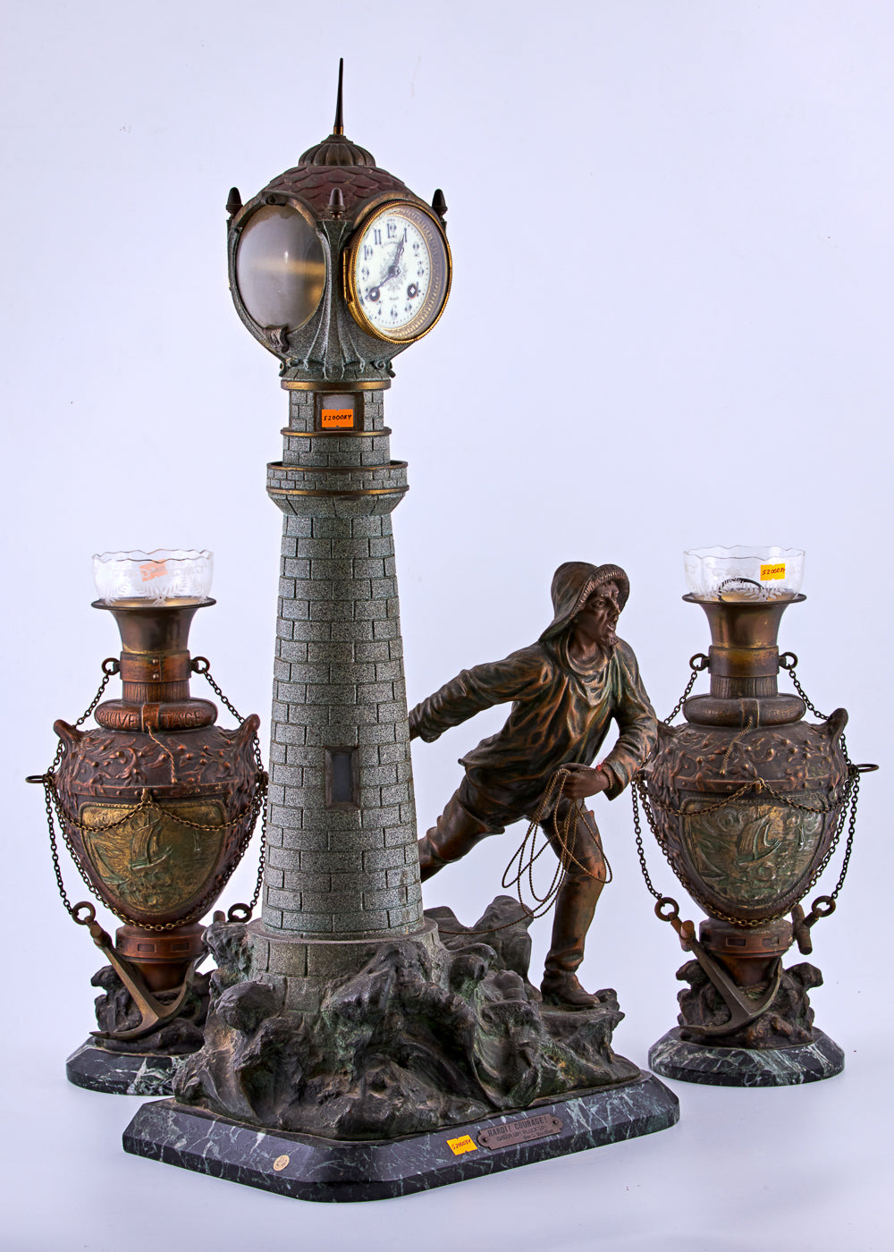 Antique distinguished spelter set captures a captivating maritime scene featuring a lighthouse and a fisherman