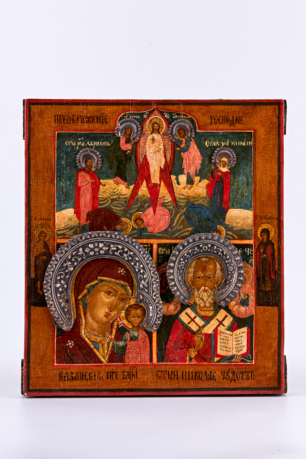 Antique icon on birch wood features three distinct motifs: “Our Lady of Kazan,” “Nicholas the Wonderworker,” and “The Transfiguration of the Lord