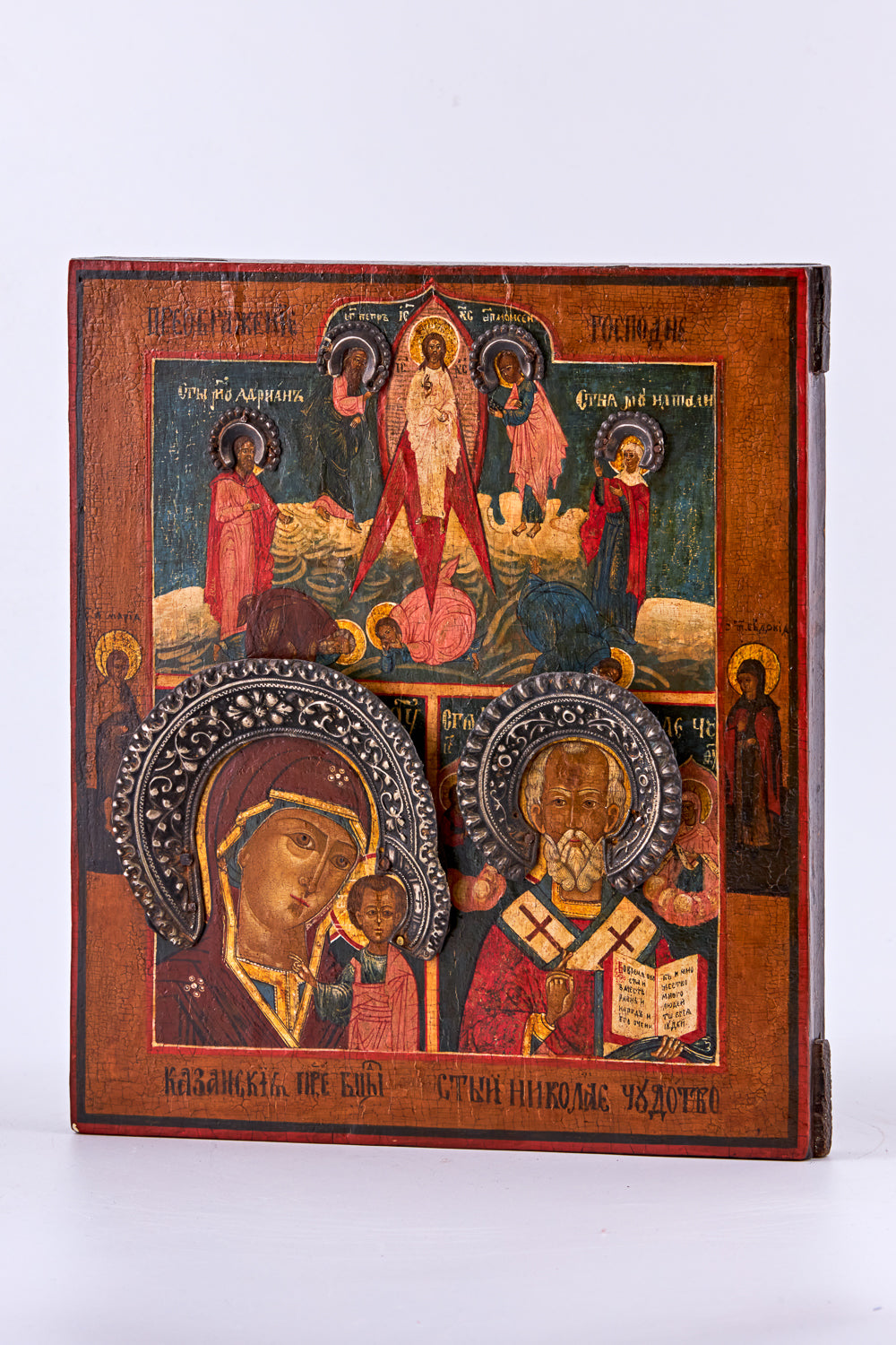 Antique icon on birch wood features three distinct motifs: “Our Lady of Kazan,” “Nicholas the Wonderworker,” and “The Transfiguration of the Lord
