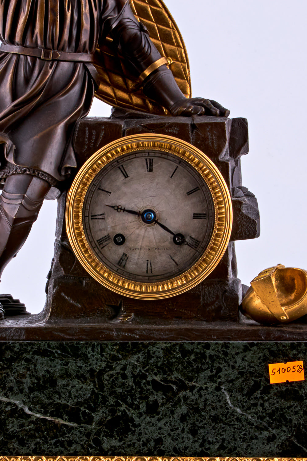 late 19th-century neoclassical clock features a finely crafted gilt bronze figurine of a knight
