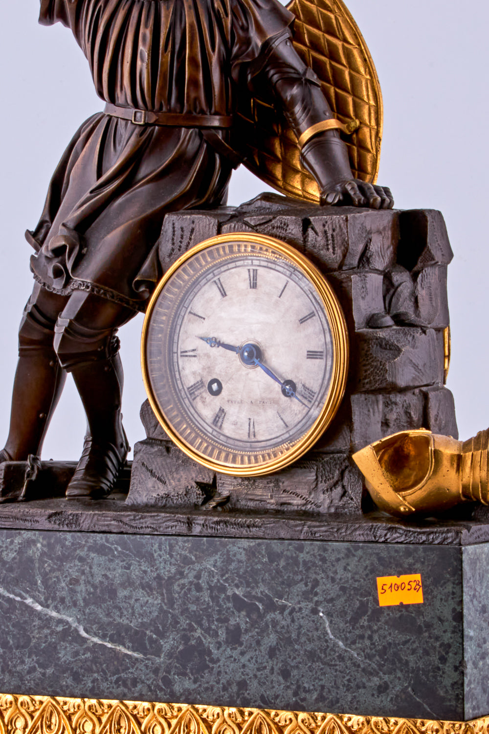 late 19th-century neoclassical clock features a finely crafted gilt bronze figurine of a knight