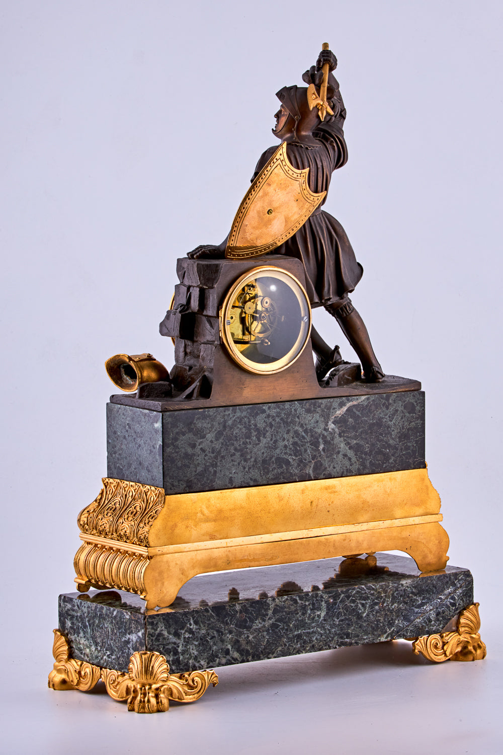 late 19th-century neoclassical clock features a finely crafted gilt bronze figurine of a knight