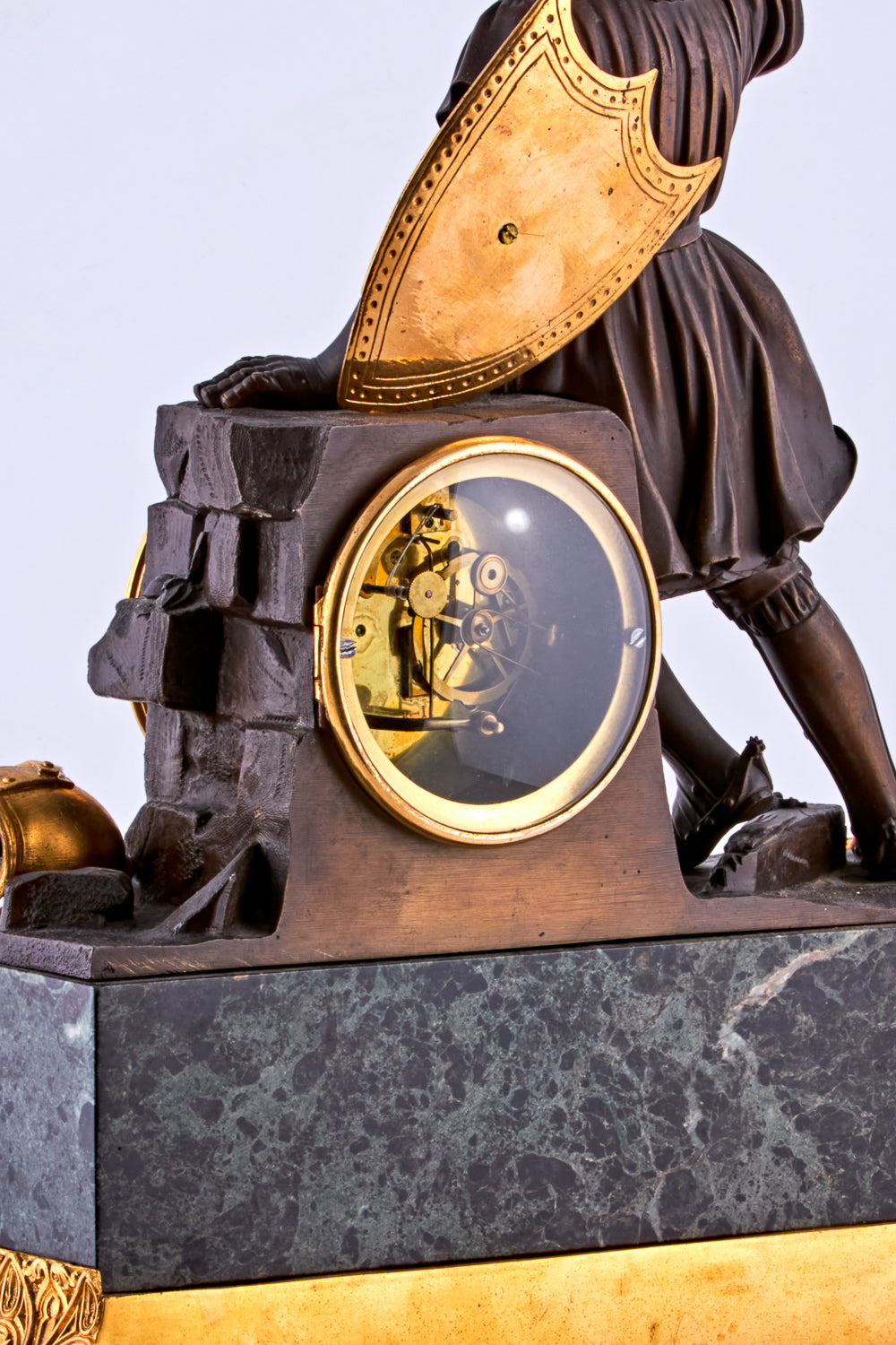late 19th-century neoclassical clock features a finely crafted gilt bronze figurine of a knight