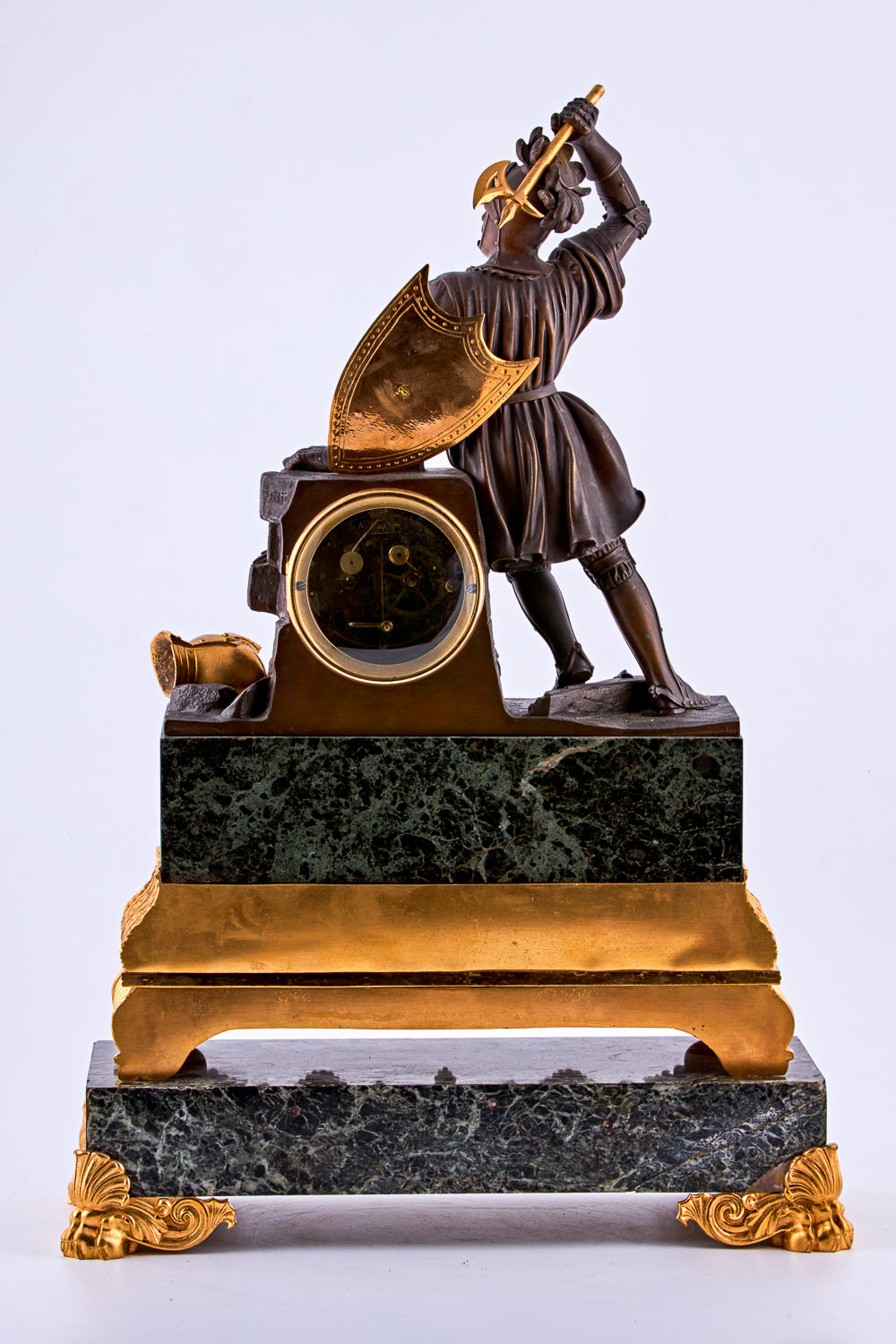 late 19th-century neoclassical clock features a finely crafted gilt bronze figurine of a knight