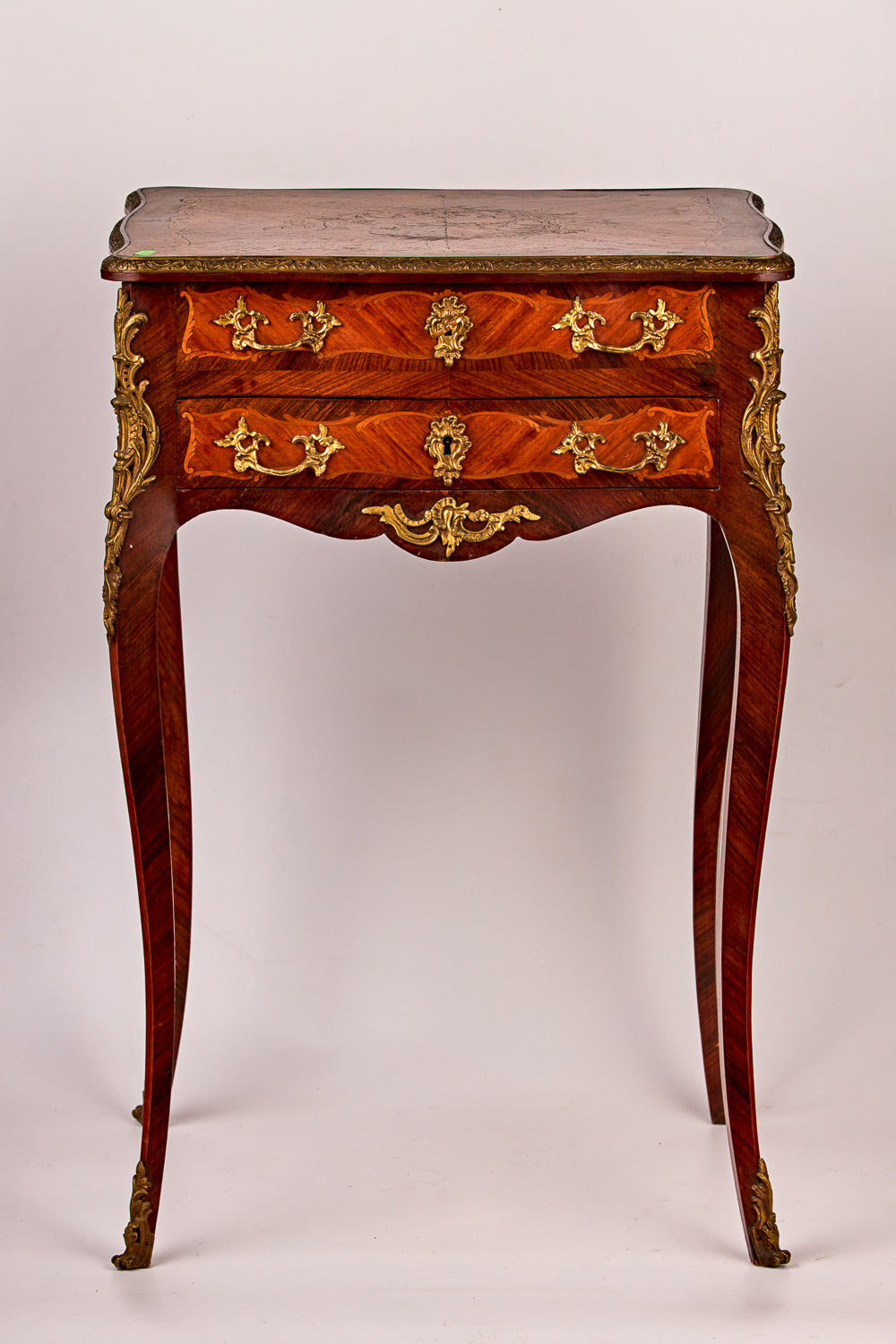Antique dresser featuring a remarkable blend of treasured wood species with intricate gilt bronze details