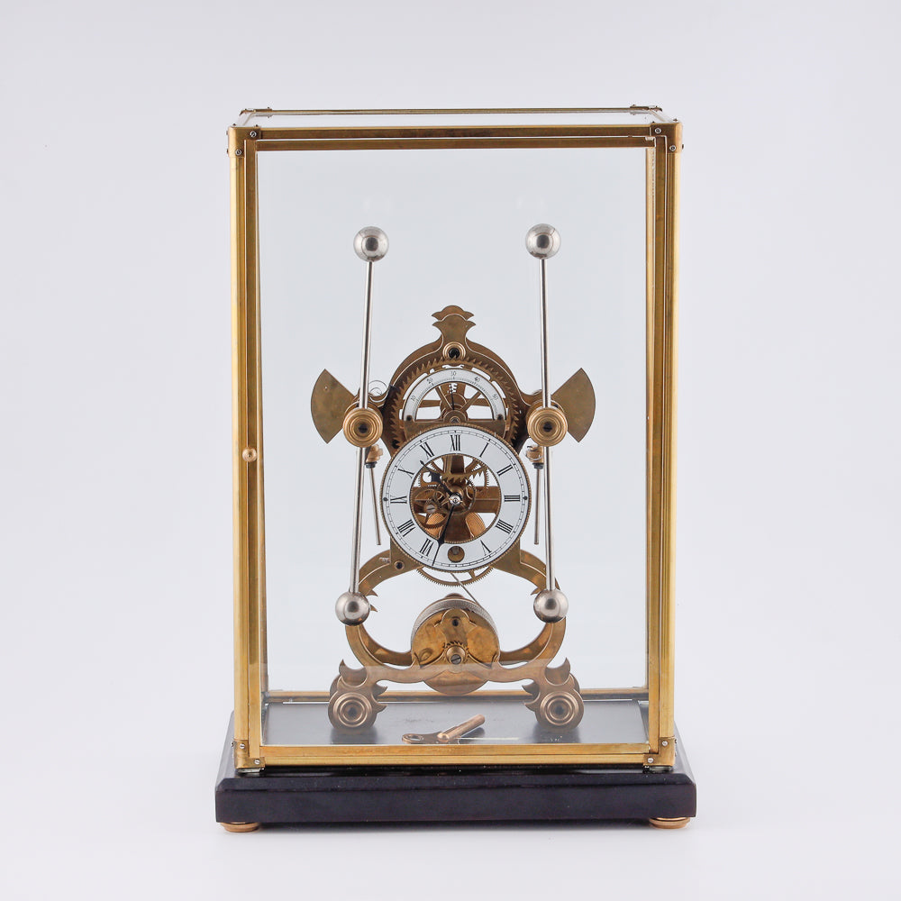 vintage Fusee Skeleton clock features a translucent glass design that showcases its intricate inner workings
