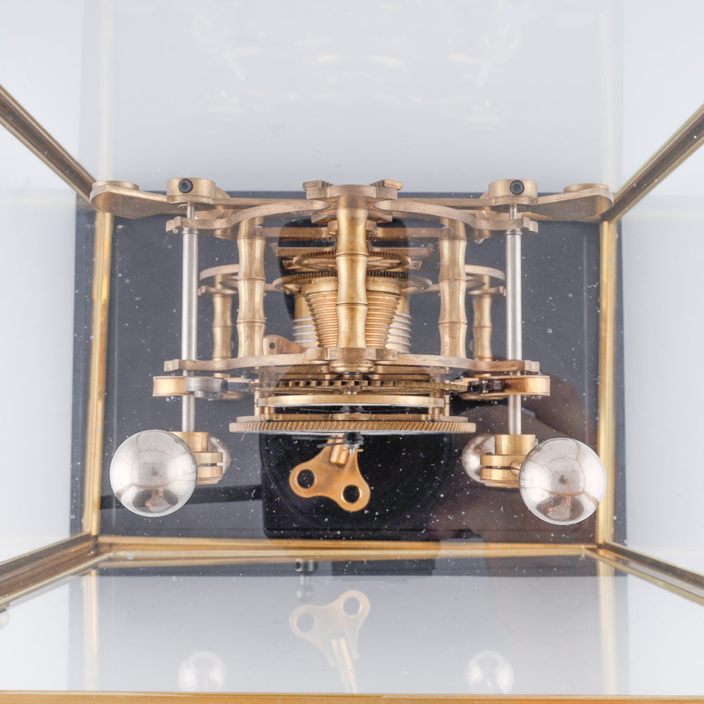 vintage Fusee Skeleton clock features a translucent glass design that showcases its intricate inner workings