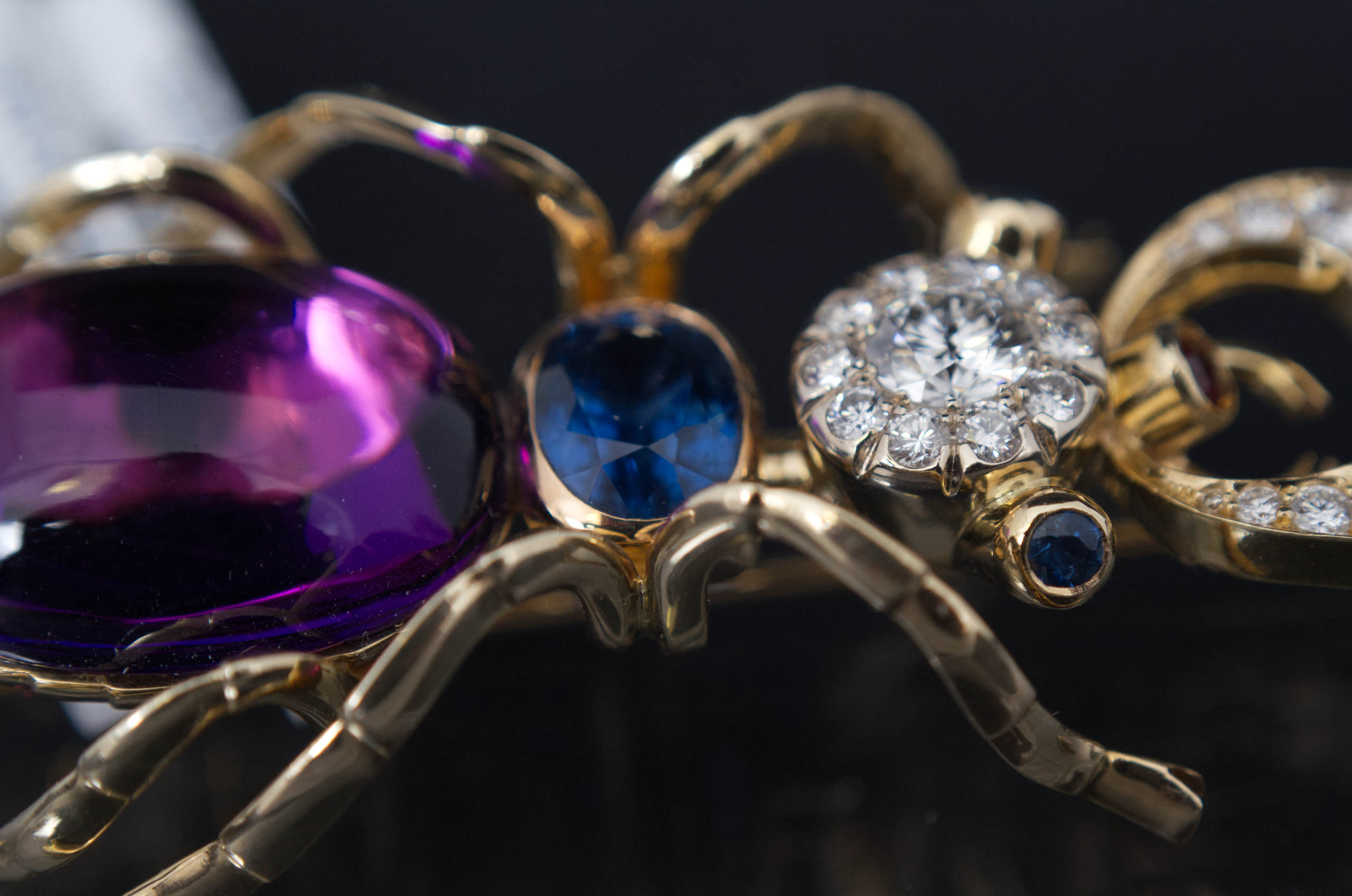 14k yellow gold pin brooch in a design of a bug set with natural diamonds, tanzanite, amethyst and emerald