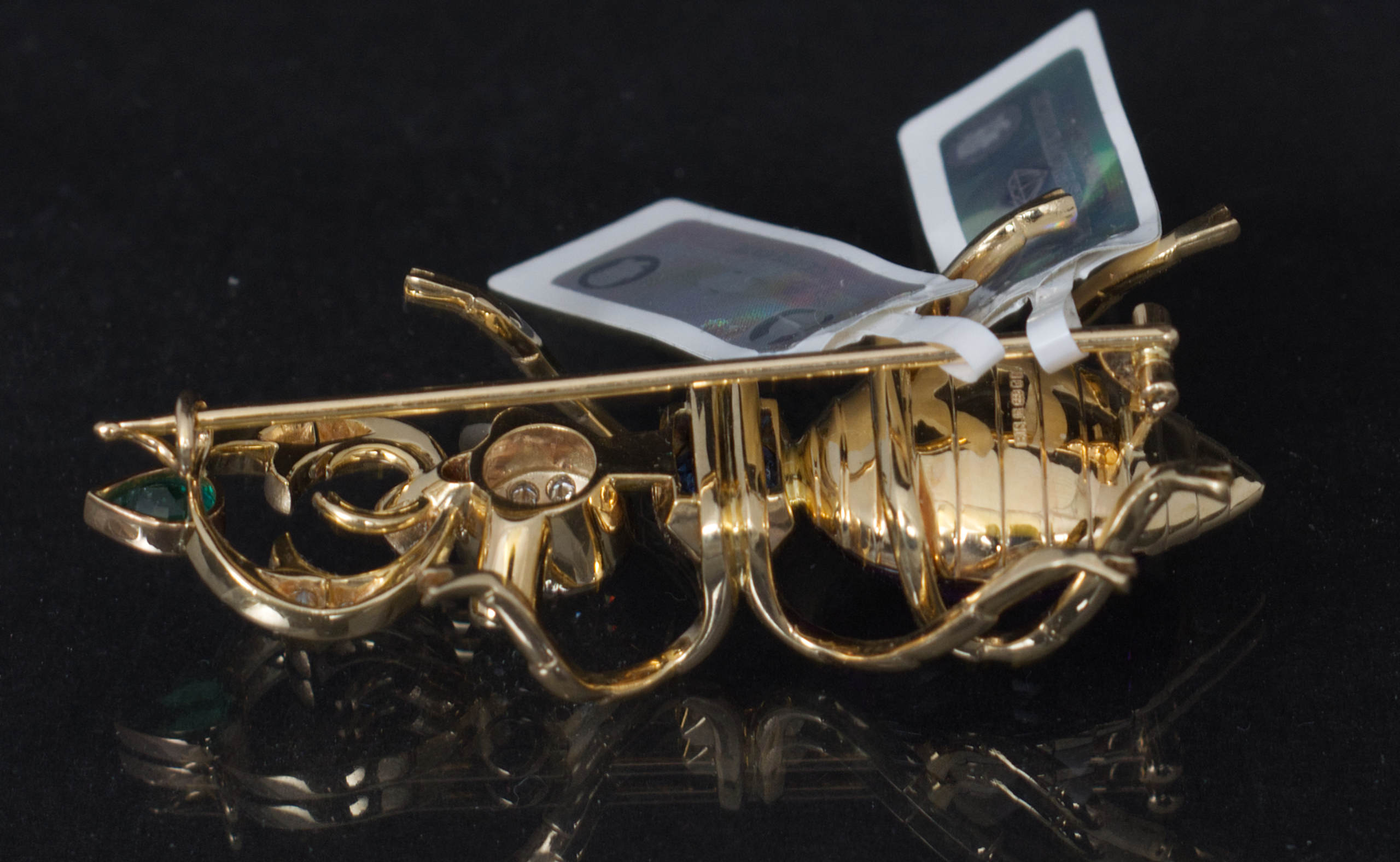 14k yellow gold pin brooch in a design of a bug set with natural diamonds, tanzanite, amethyst and emerald