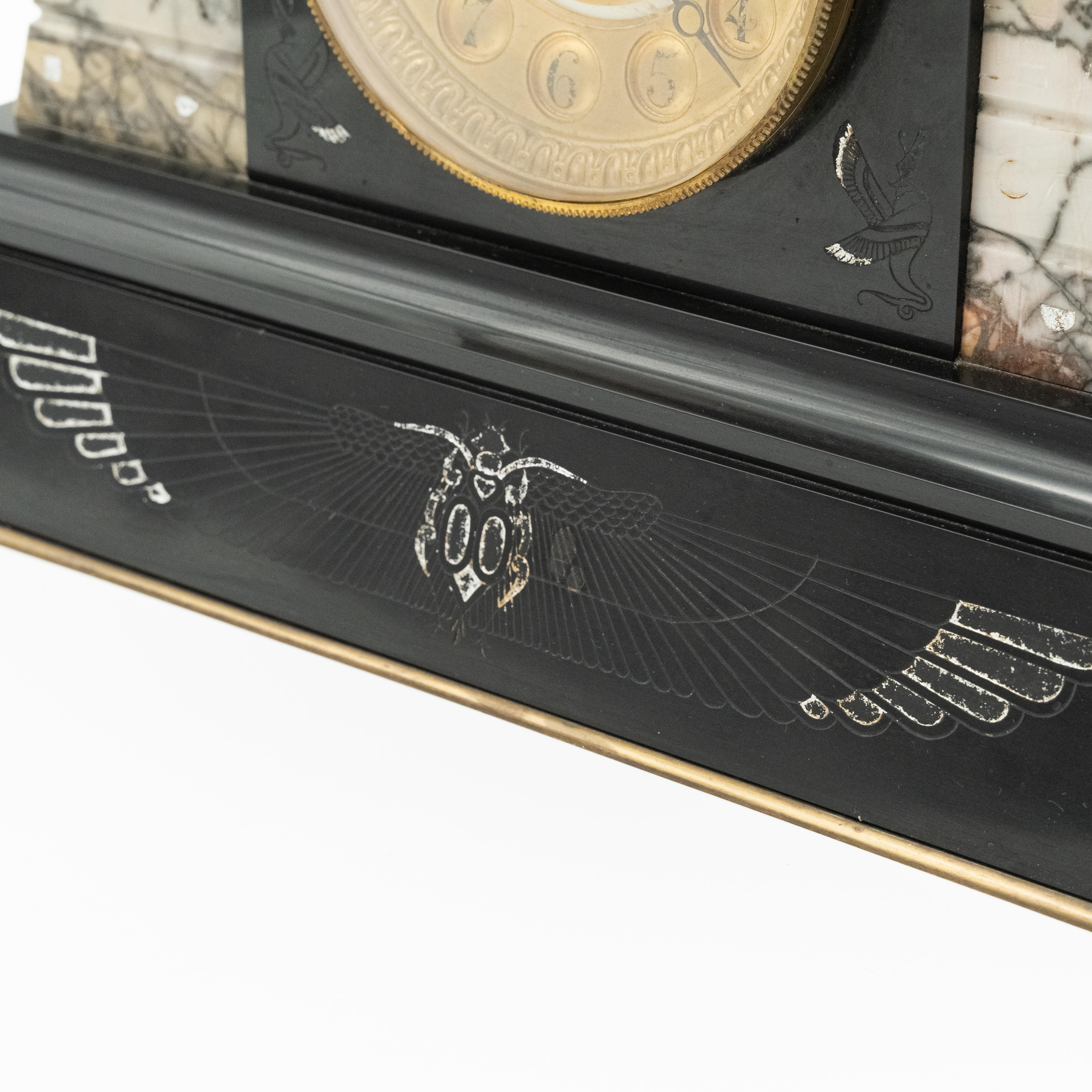 Reloj de sobremesa antiguo de mármol con motivo egipcio decorado con una esfinge alada en la parte superior