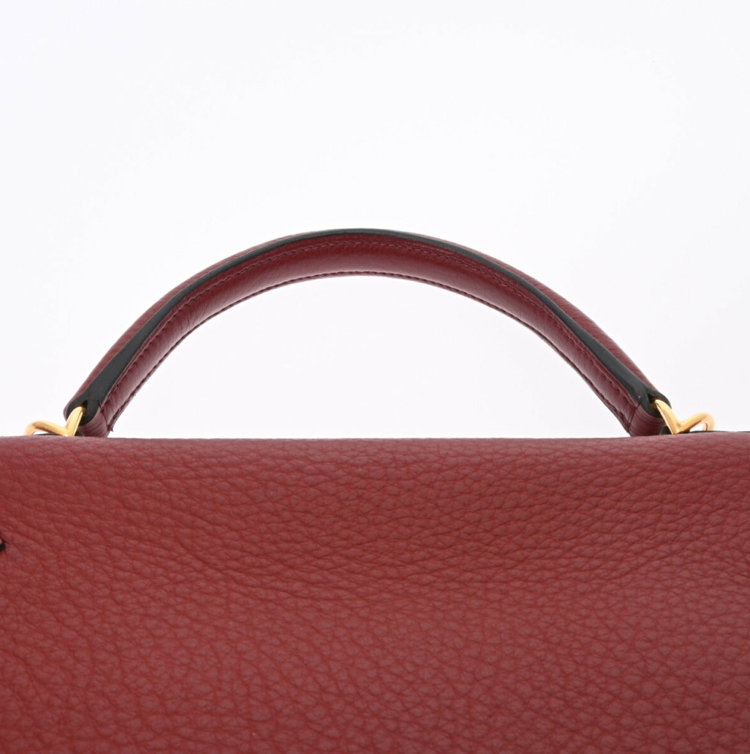Hermes Kelly 32 in a red leather with a strap and accessories
