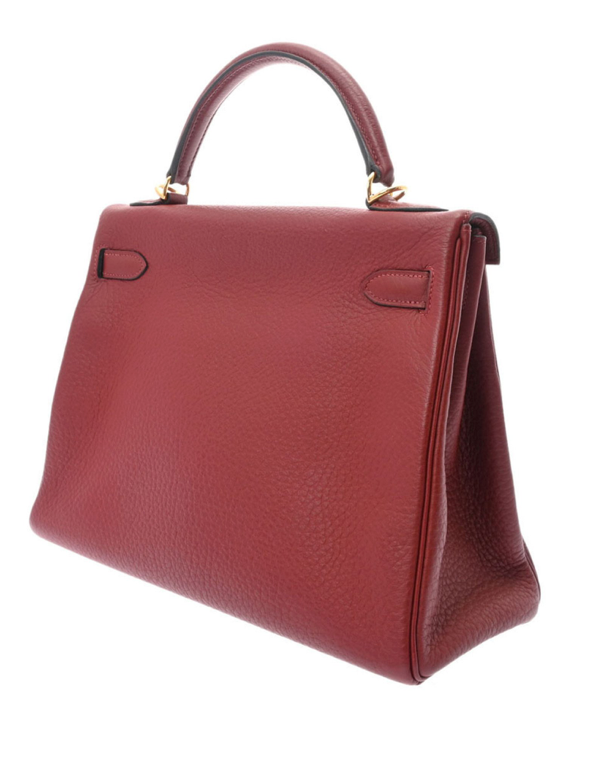 Hermes Kelly 32 en cuero rojo con correa y accesorios.