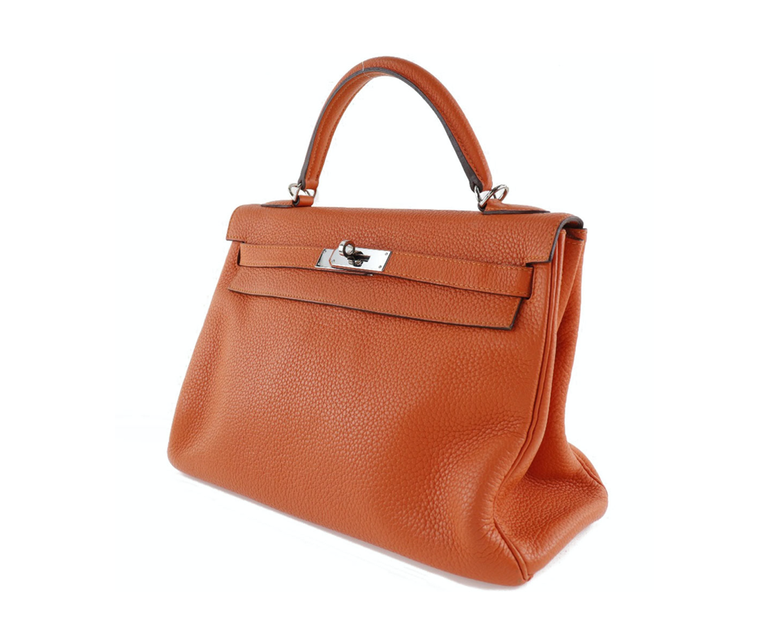 El bolso Clemence de cuero naranja Hermes Kelly 32 viene con accesorios