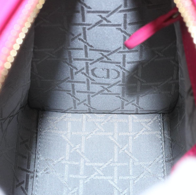 Lady Dior mini handbag in fuchsia lambskin leather with a long strap