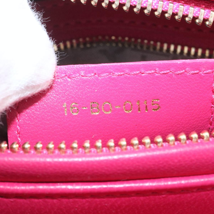 Lady Dior mini handbag in fuchsia lambskin leather with a long strap