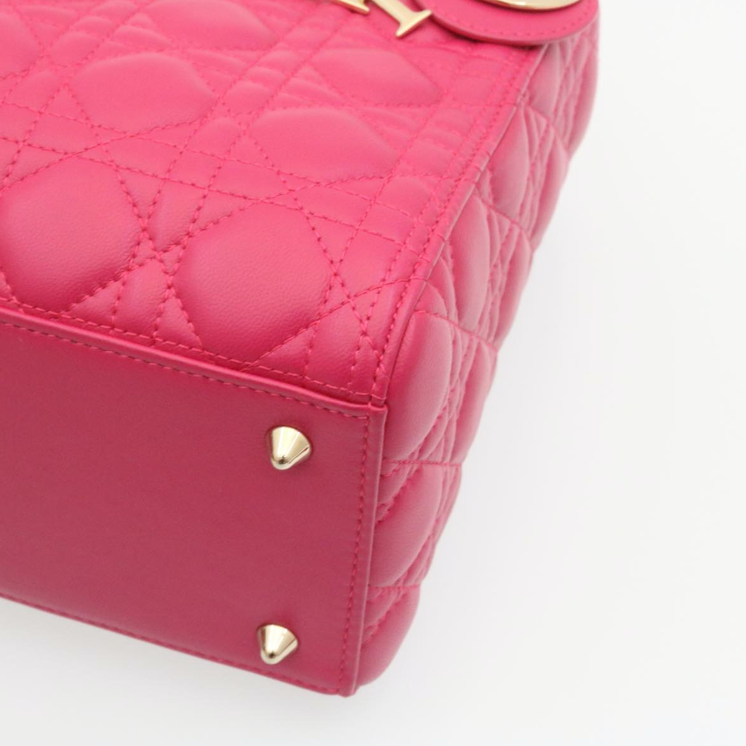 Lady Dior mini handbag in fuchsia lambskin leather with a long strap