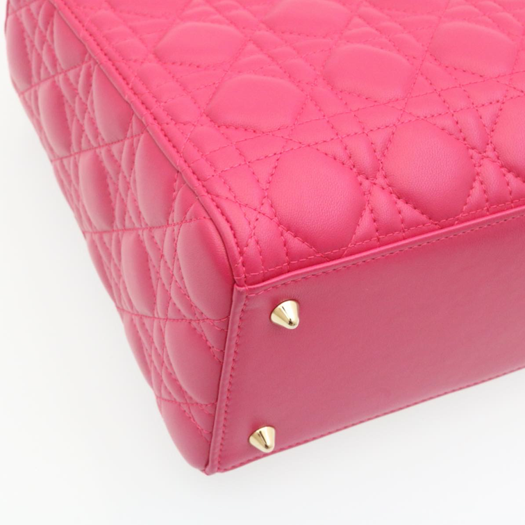 Lady Dior mini handbag in fuchsia lambskin leather with a long strap