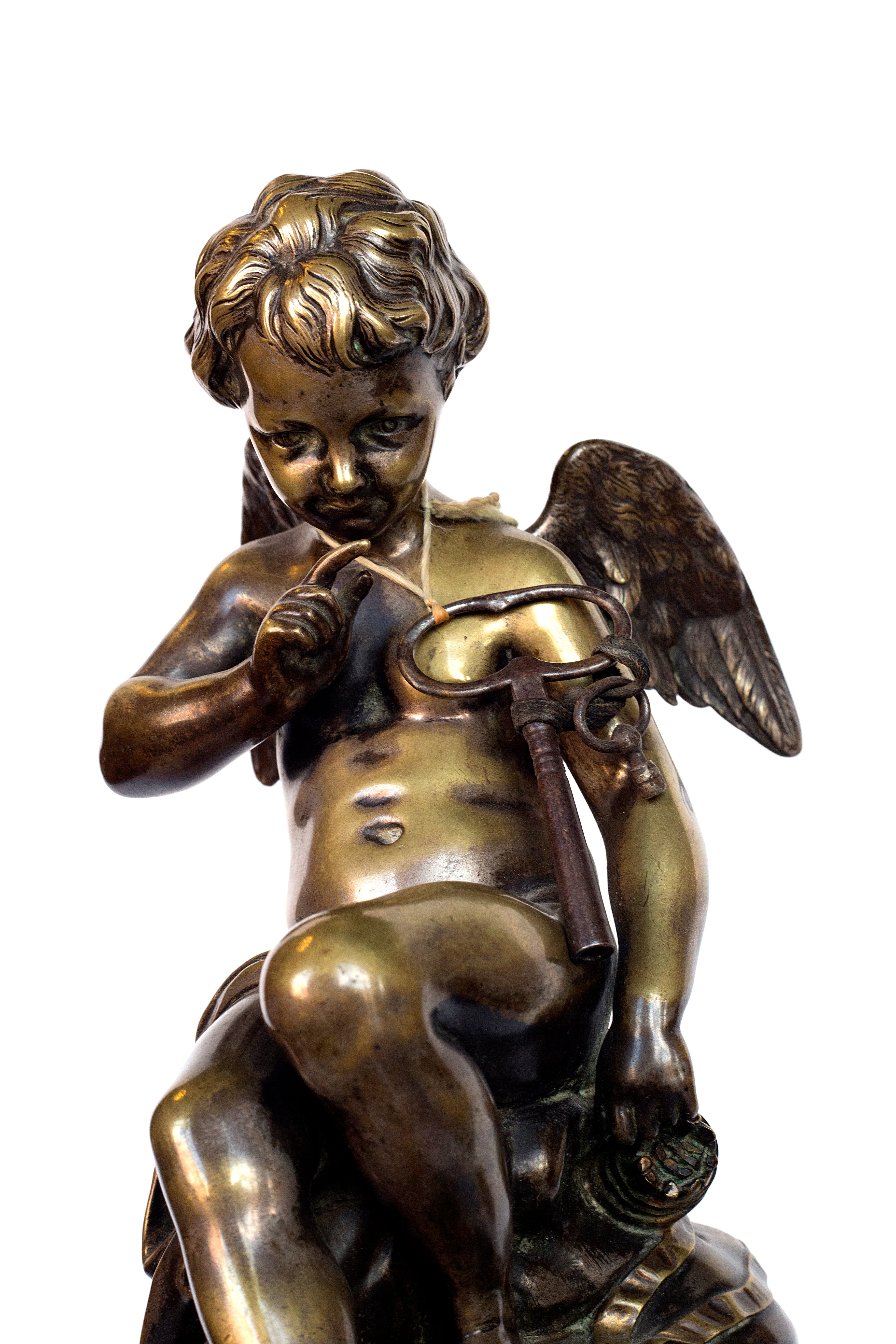 Antique handcrafted bronze clock sits atop a stone plinth, featuring a sculpture of a Putti, inspired by the French Rococo sculptor Clodion (Claude Michel)
