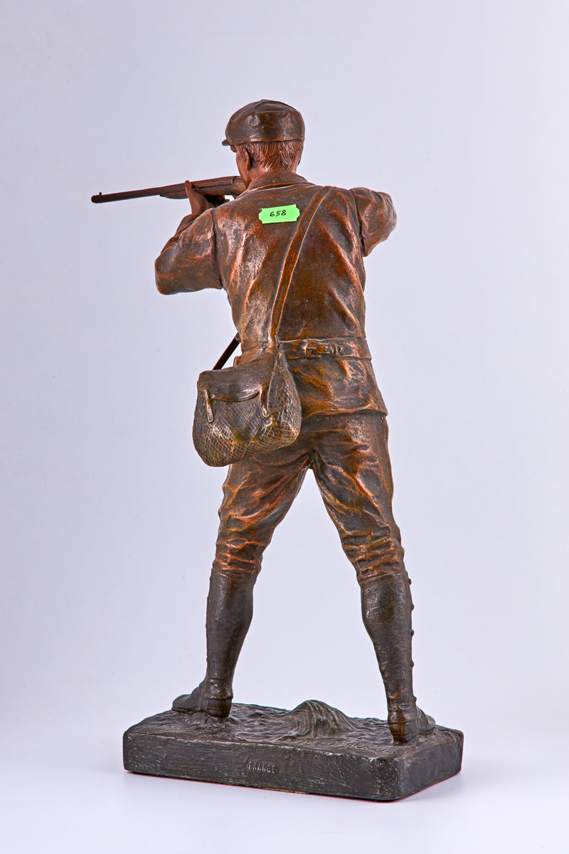 Patinated spelter statuette of a hunter by Henri Fugere