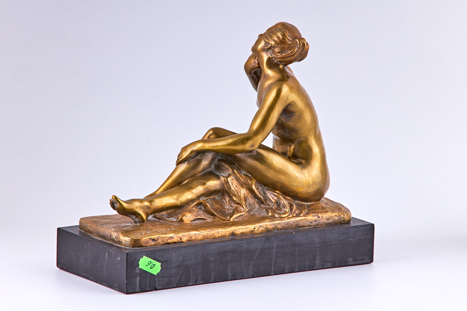 An early 20th century gold plated bronze sculpture of nude lady and a bird