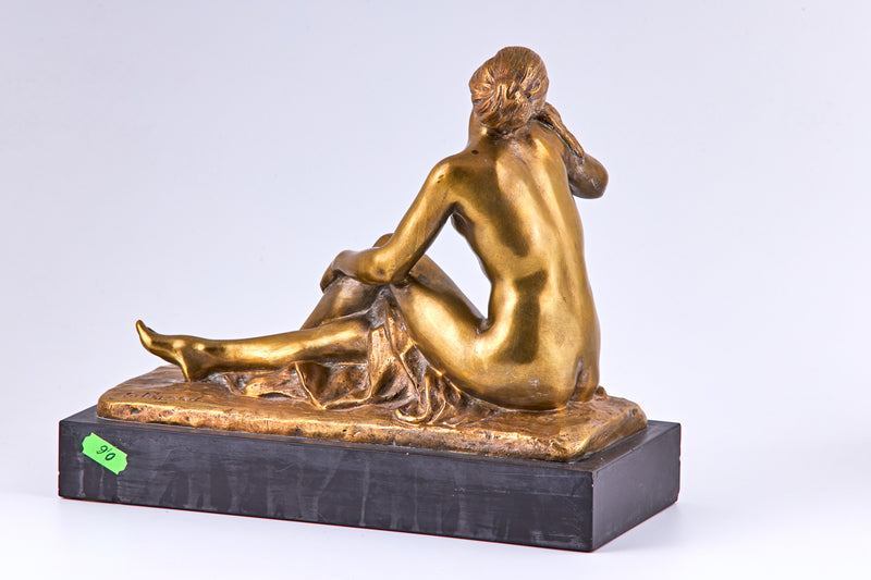 An early 20th century gold plated bronze sculpture of nude lady and a bird